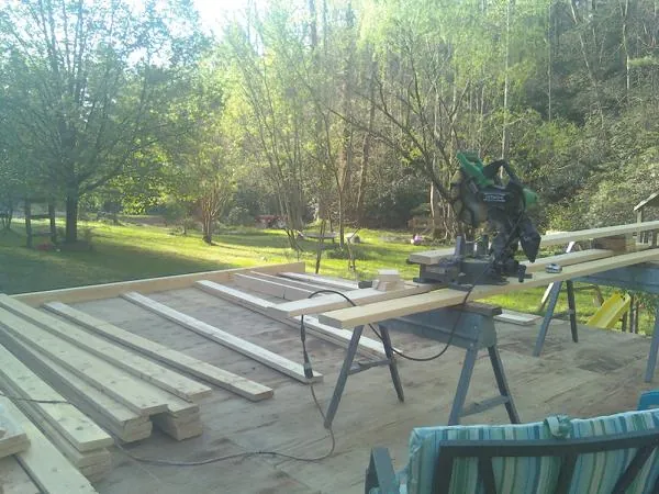 Miter saw and framing lumber on a deck under construction in Casselton