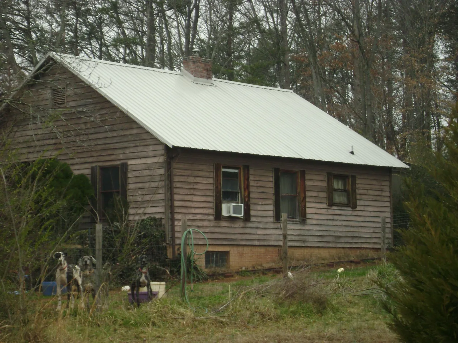 White metal roof on an old wood sided farmhouse, from a Metal Roof Installation job in Casselton